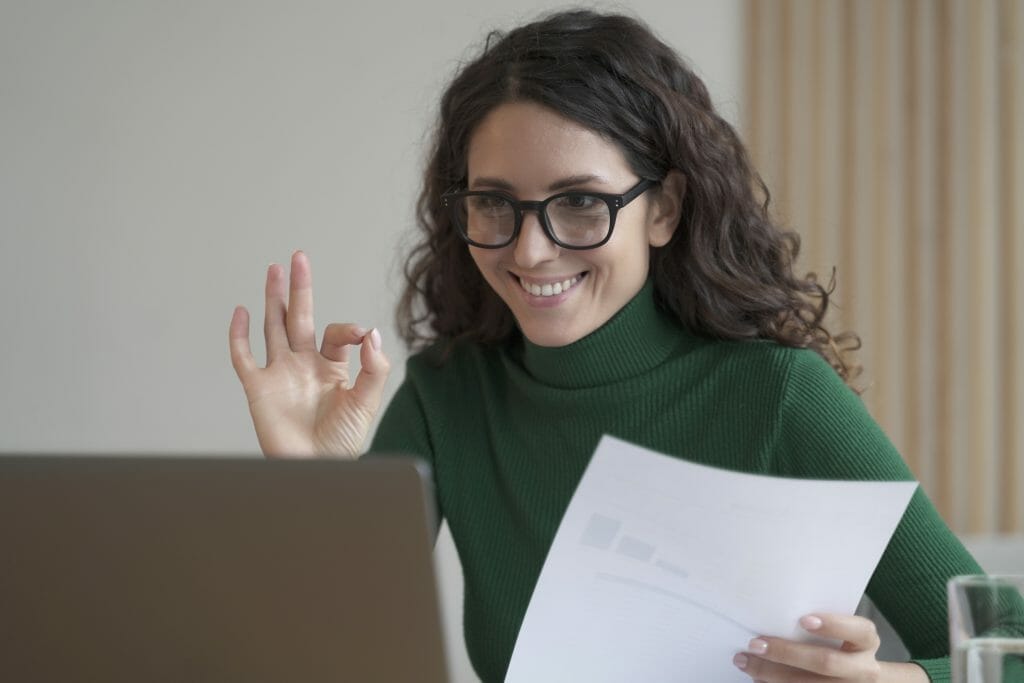 Smiling female employee holding financial documents